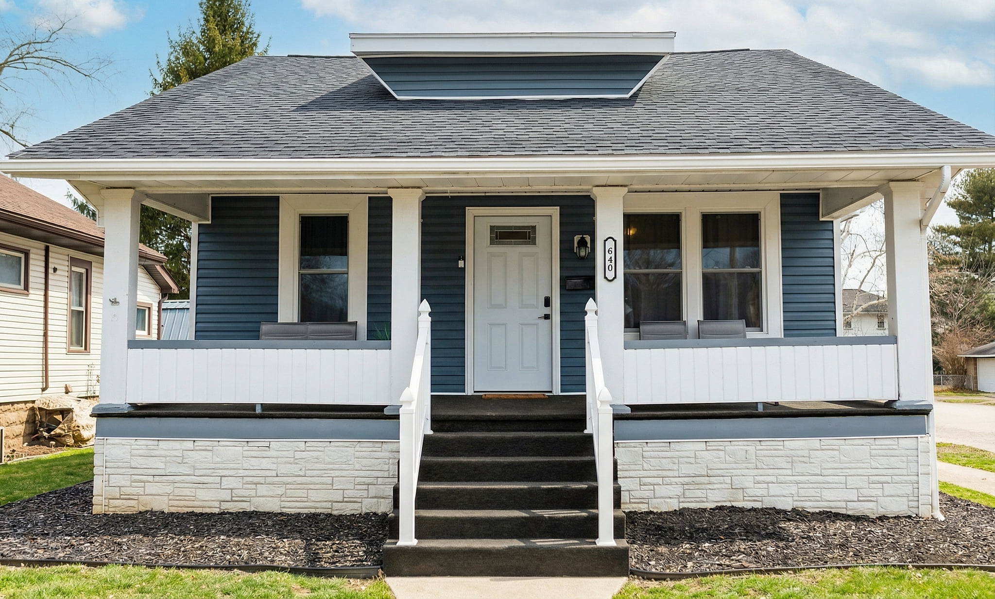 Charming blue bungalow with roomy covered porch on a quiet street