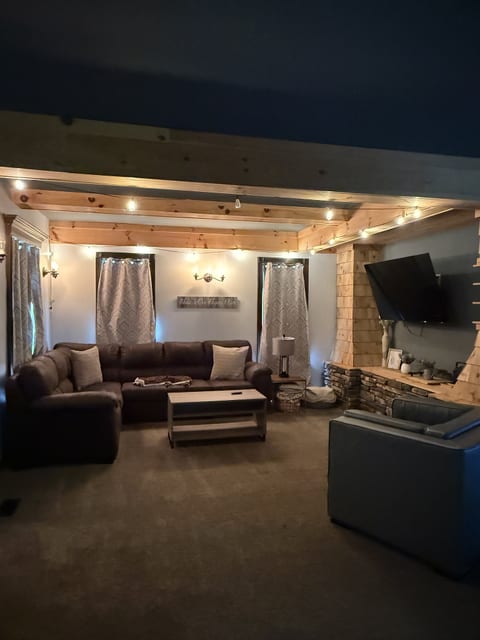 Cozy rustic living room with stone fireplace and spacious sectional