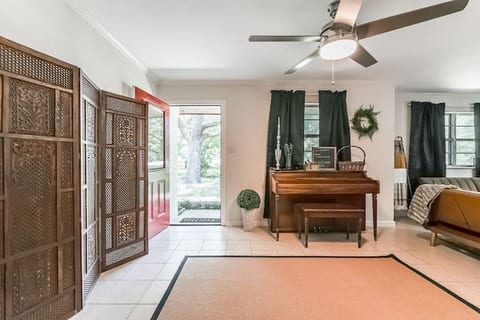 The entry for the home with a usable upright piano.