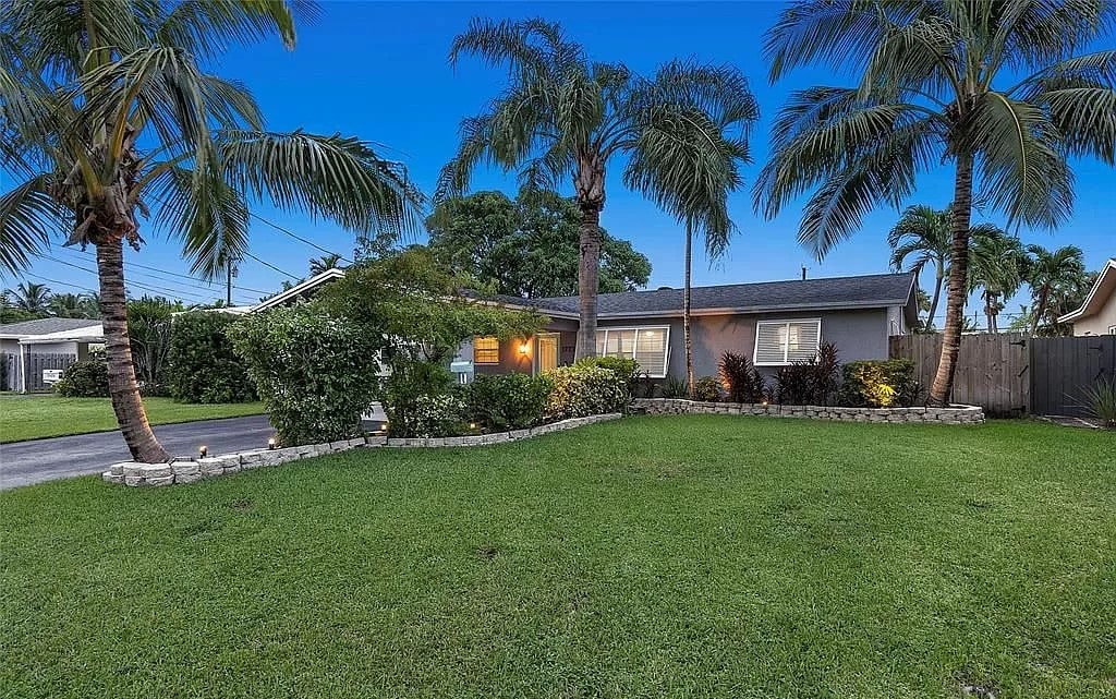 Front of House Provides Spacious Driveway & Elegant Landscape Lighting at Dusk