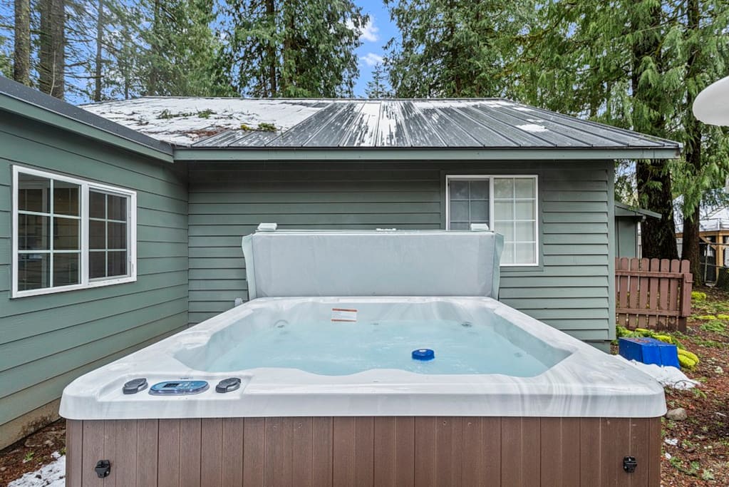 The hot tub is steps from the back door