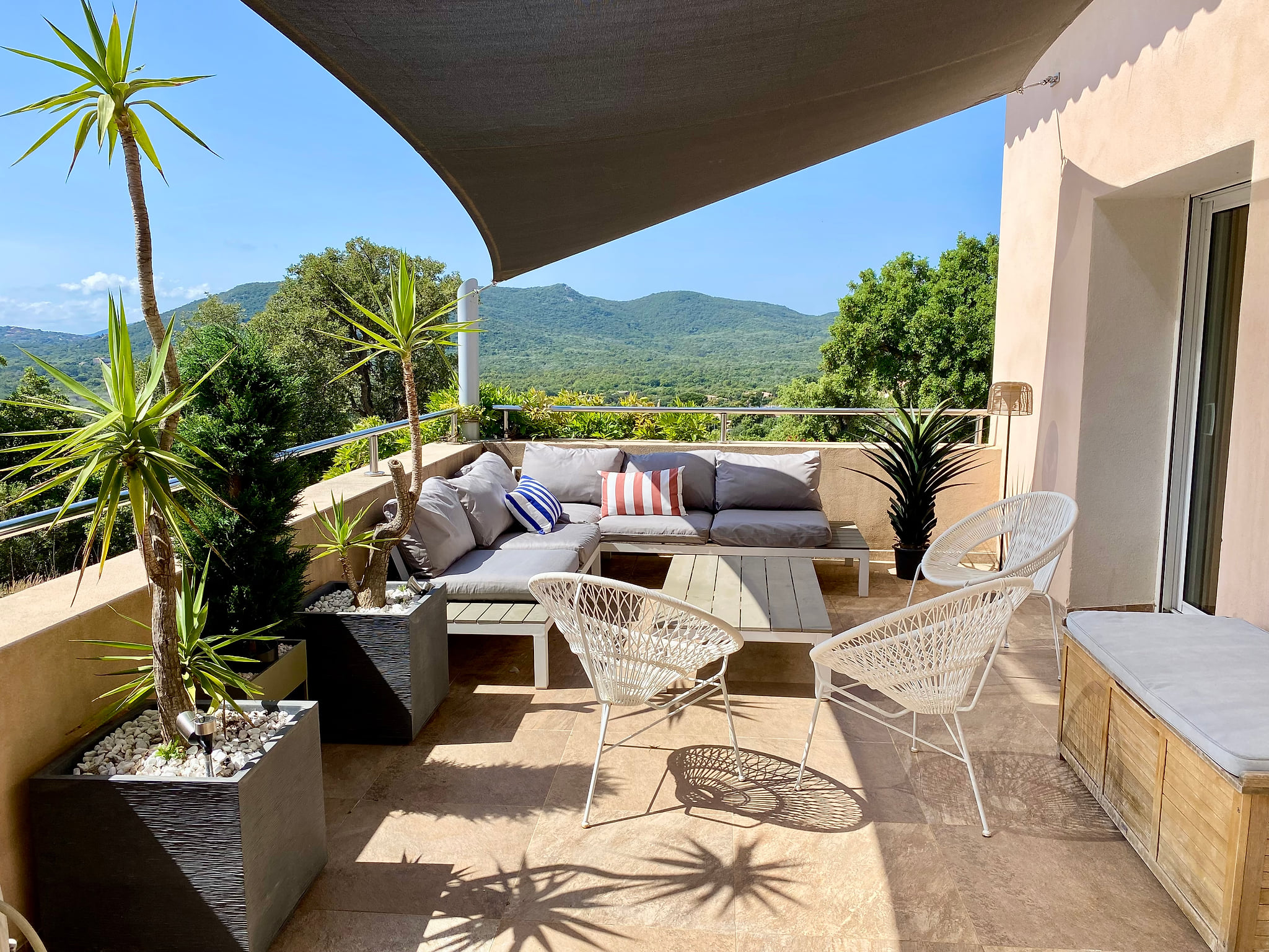 Oustide living room with maquis view