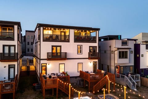 Exterior | Dual Homes | Rooftop & Decks | Backyard View
Two modern three-story homes with rooftop decks, private balconies, and bistro-lit back patios—perfectly designed for large groups to relax, connect, and celebrate in style.