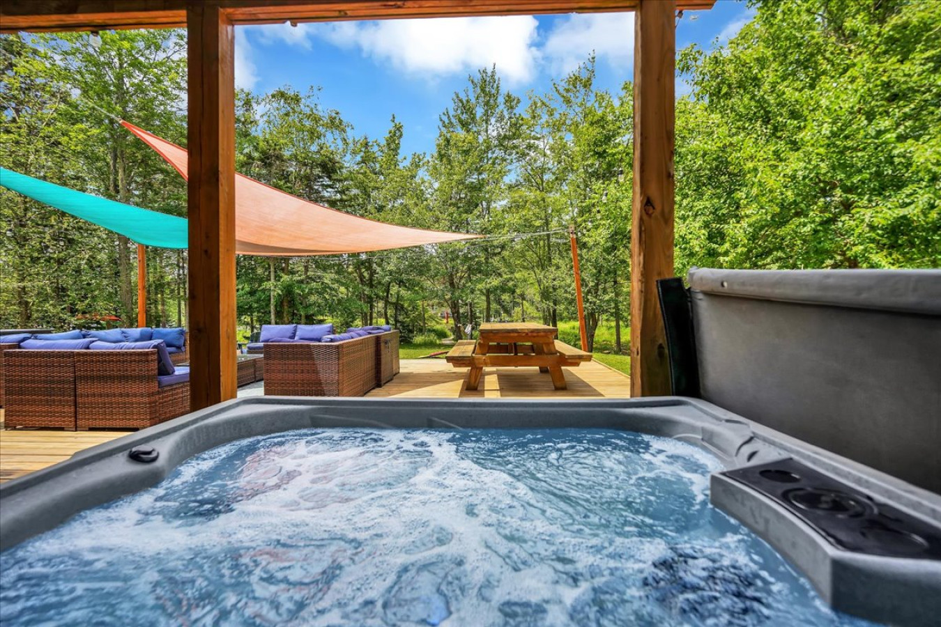 Soak, unwind, and take in the peaceful surroundings from your private hot tub retreat.