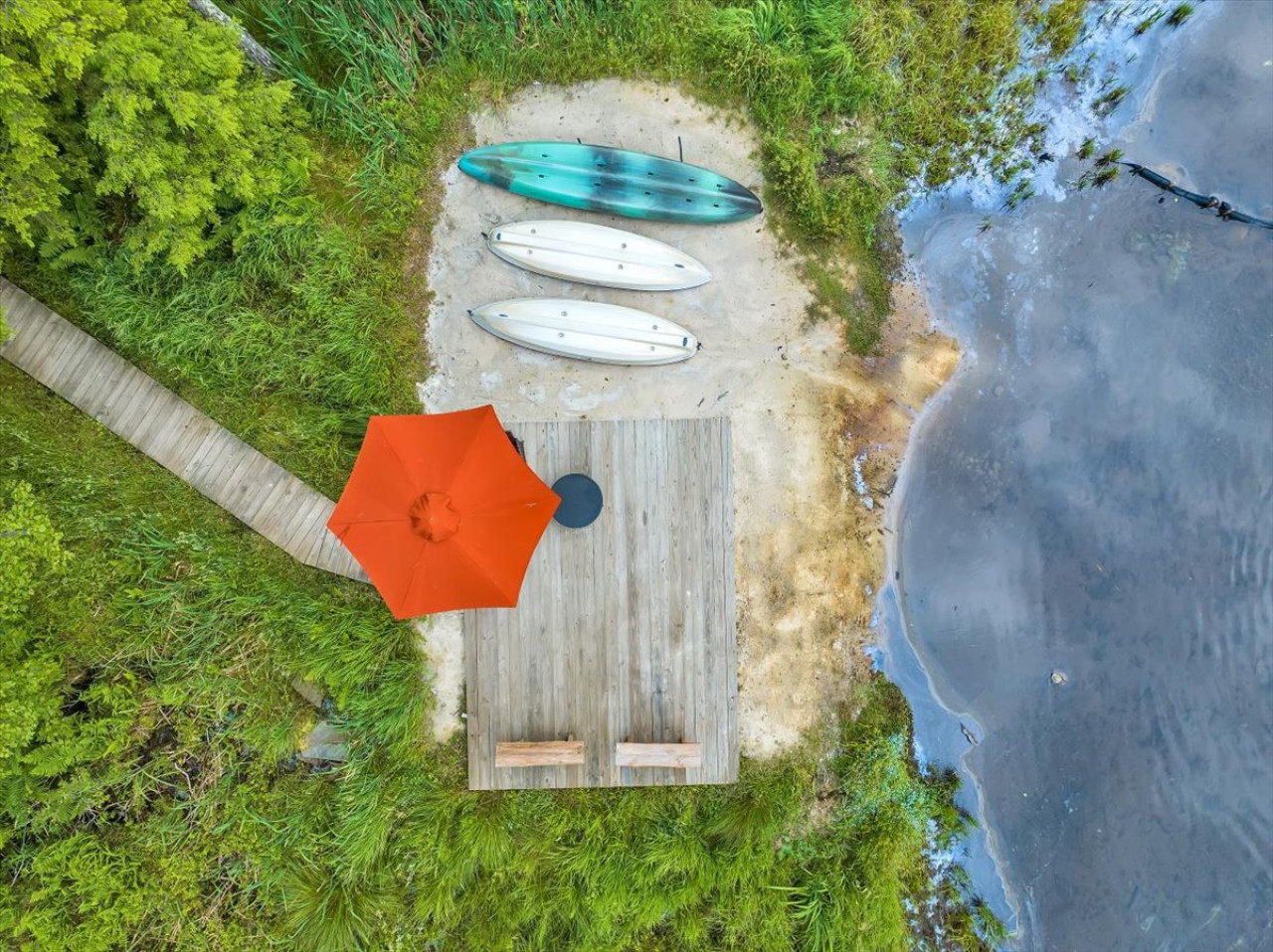 Your own private lakeside escape — complete with kayaks, cozy seating, and an umbrella for shade. Perfect for morning coffee or sunset paddles.