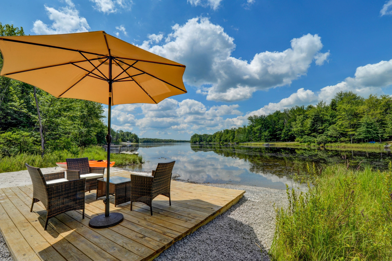 Your own private lakeside escape — complete with kayaks, cozy seating, and an umbrella for shade. Perfect for morning coffee or sunset paddles.