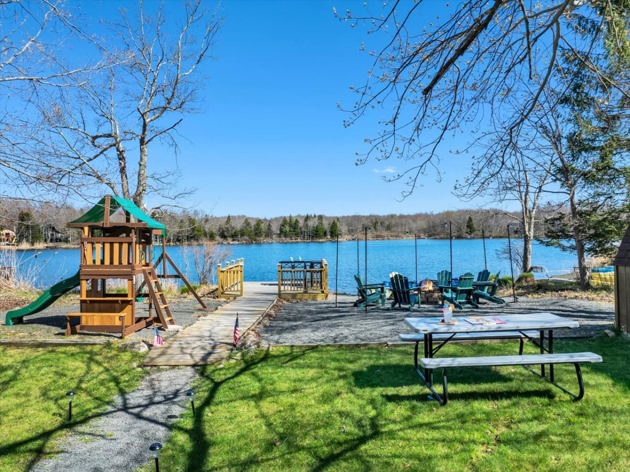 Fun for all ages! The lakefront play area features a swing and slide combo, perfect for kids to enjoy the outdoors.