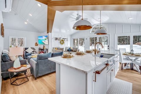 An inviting open kitchen and dining area with everything you need to cook, gather, and enjoy cozy meals together during your winter getaway.