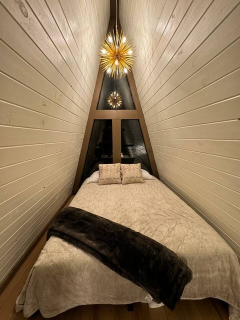 Loft queen bed at night. The starburst light is on a dimmer to ensure the perfect lighting when relaxing to sleep.