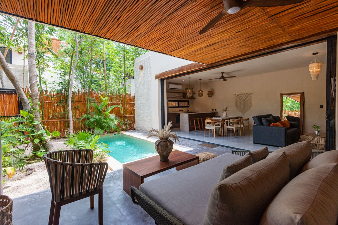 Peaceful private patio featuring a refreshing plunge pool and lush greenery all around. The cozy seating area offers an ideal space to unwind and recharge.