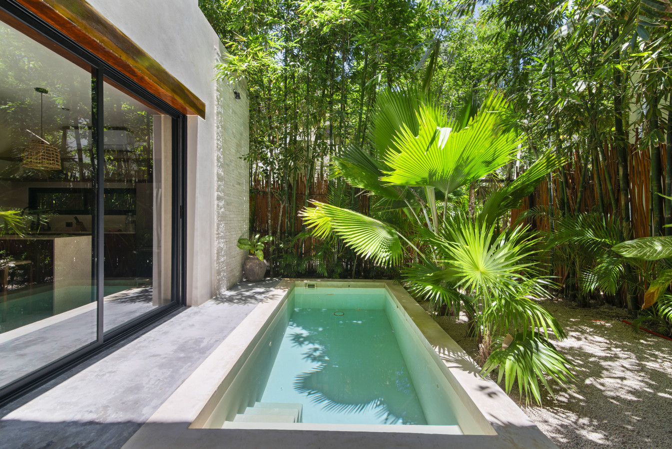 Take a refreshing dip in your private pool, nestled among lush tropical greenery, with ample space to lounge and bask in the sun.