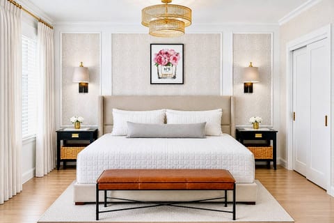 A serene, boutique-style king suite featuring custom wallpaper, layered luxury linens, and beautifully styled built-ins—designed for slow mornings and elevated stays.