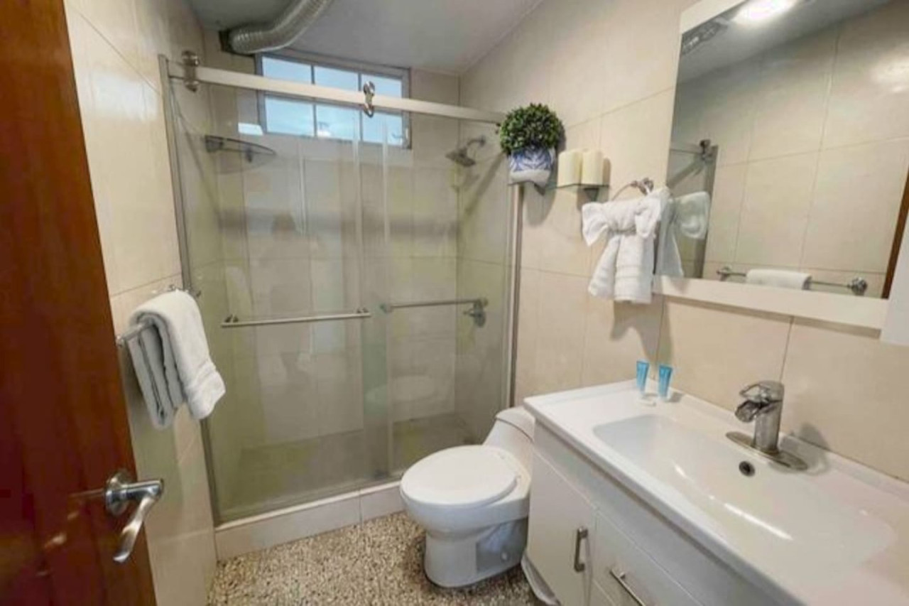 Bathroom: Modern elegance with a spacious shower and stylish fixtures for your relaxation.