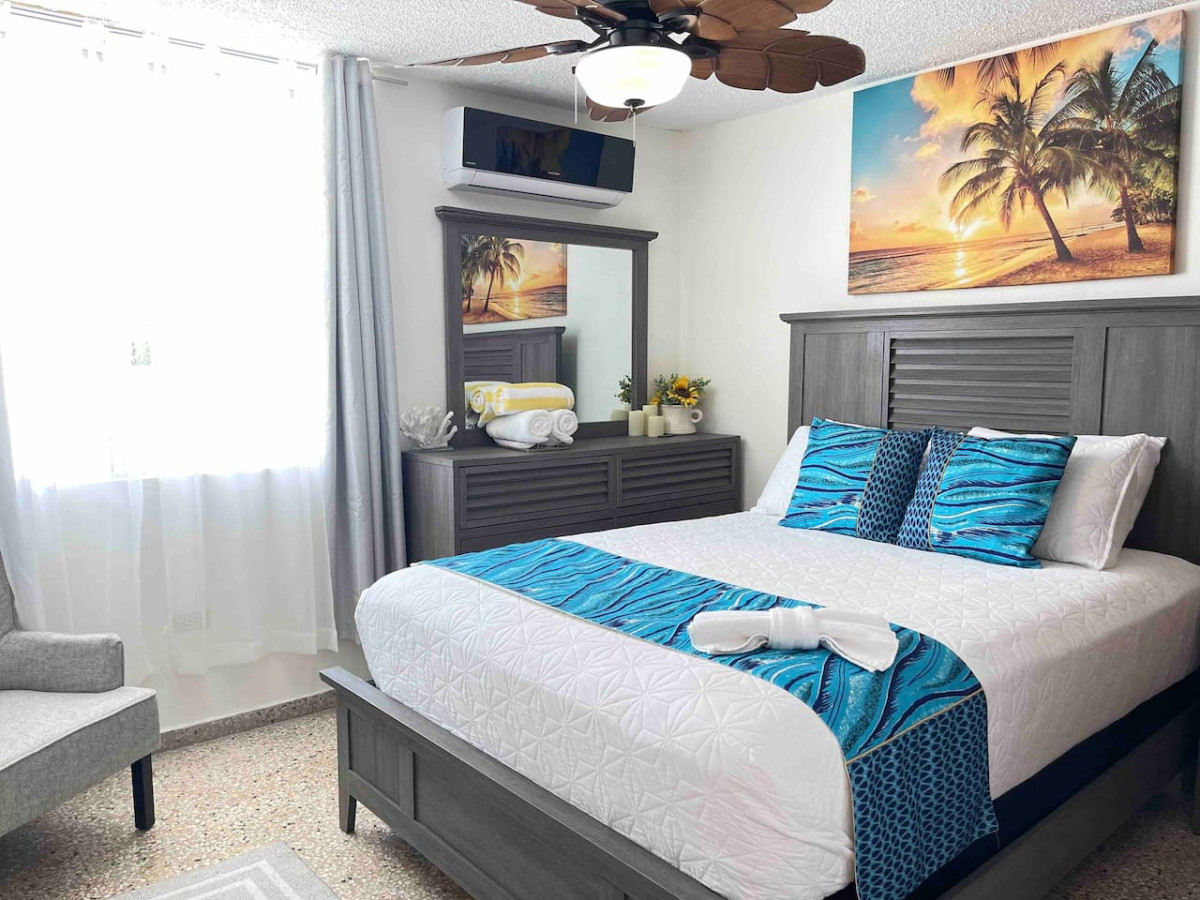 1st Bedroom With Queen Bed and 55" Smart TV with Pool and Ocean View.