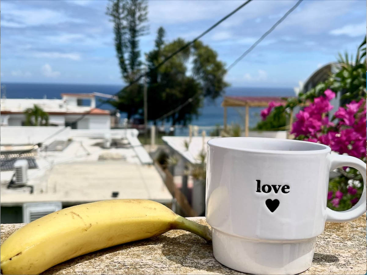 Patio Bliss: Sip your morning coffee with ocean views and vibrant tropical blooms!