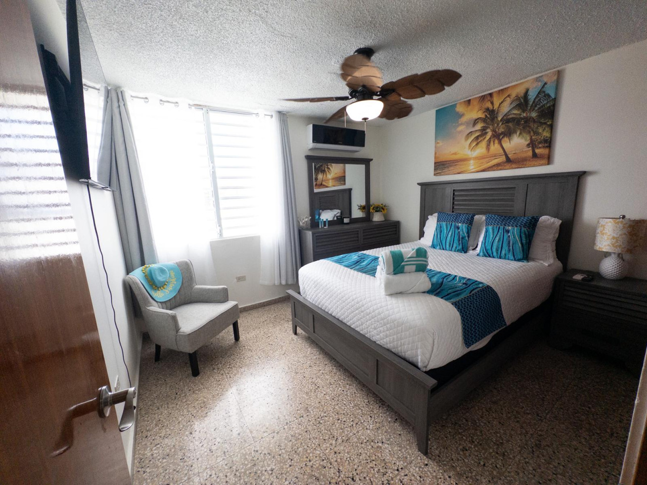 1st Bedroom: Relax in style with ocean views, 55" TV, and vibrant beach-themed decor!