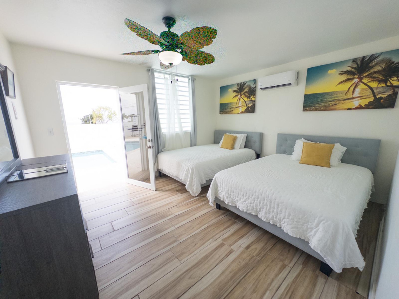 Bedroom Retreat: Bright space with two queen beds, artful decor, and poolside access!