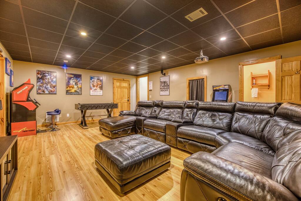 Immerse yourself in stunning high-definition entertainment on the 100" screen. This inviting space is perfect for movie nights, gaming, or streaming your favorite shows in ultimate comfort and style. Immerse yourself in stunning high-definition entertainment on the 100" screen. This inviting space is perfect for movie nights, gaming, or streaming your favorite shows in ultimate comfort and style. - Spacious Cabin, Hot Tub, Theater, Dog Run, FirePit - Ellijay