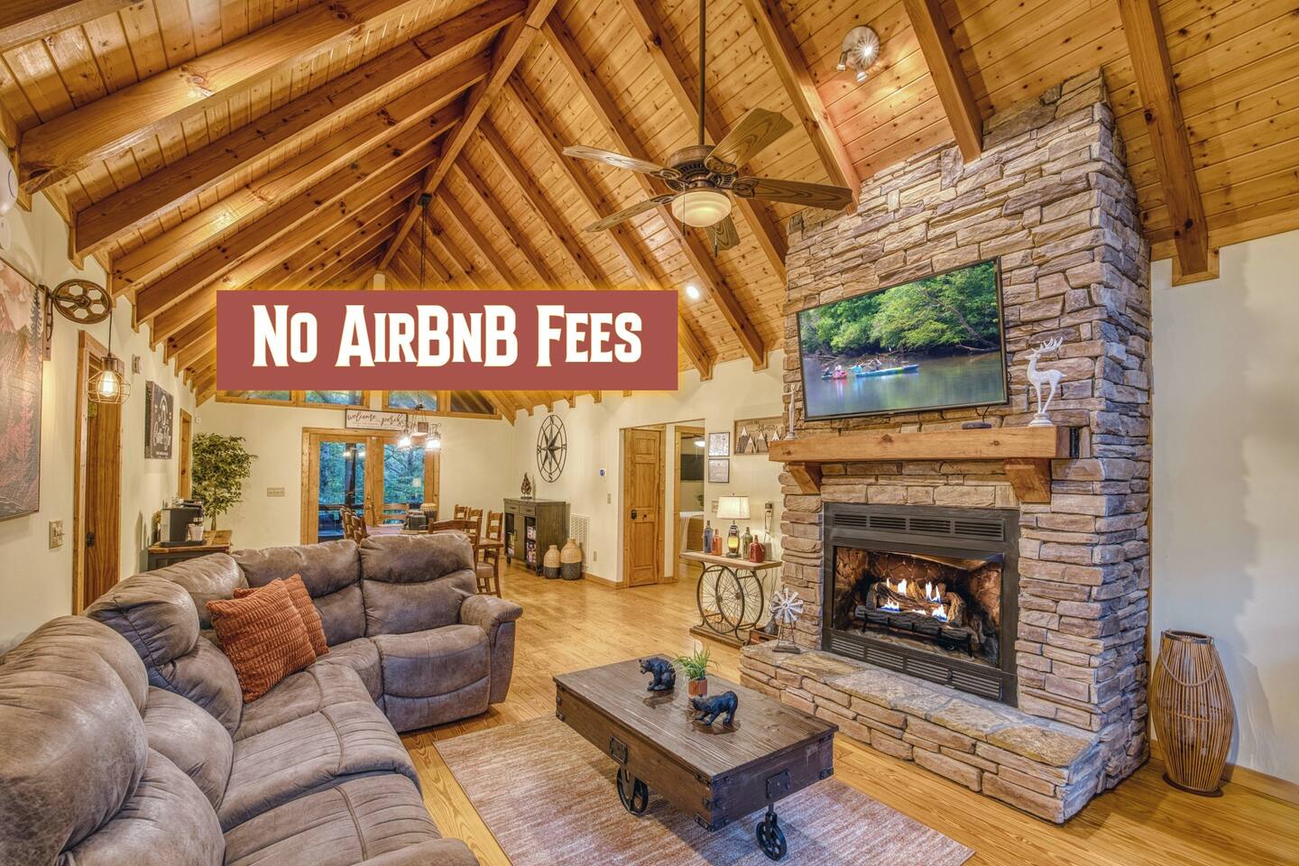 Sink into the cozy sectional couch by the stacked stone gas fireplace and Smart TV. The Vaulted ceilings, natural light, and open-concept design make this the perfect spot to relax.