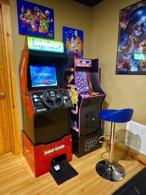 Relive the classics with Ridge Racer and Ms. Pacman arcade games, set against a backdrop of decorative gaming wall art and iconic movie posters. This space is perfect for a fun, retro gaming experience with a cinematic twist!
Relive the classics with Ridge Racer and Ms. Pacman arcade games, set against a backdrop of decorative gaming wall art and iconic movie posters. This space is perfect for a fun, retro gaming experience with a cinematic twist!
- Spacious Cabin, Hot Tub, Theater, Dog Run, FirePit - Ellijay