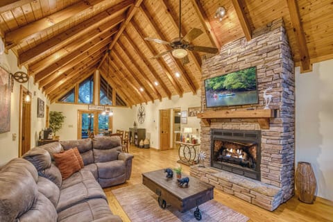 Sink into the cozy sectional couch by the stacked stone gas fireplace and Smart TV. The Vaulted ceilings, natural light, and open-concept design make this the perfect spot to relax.