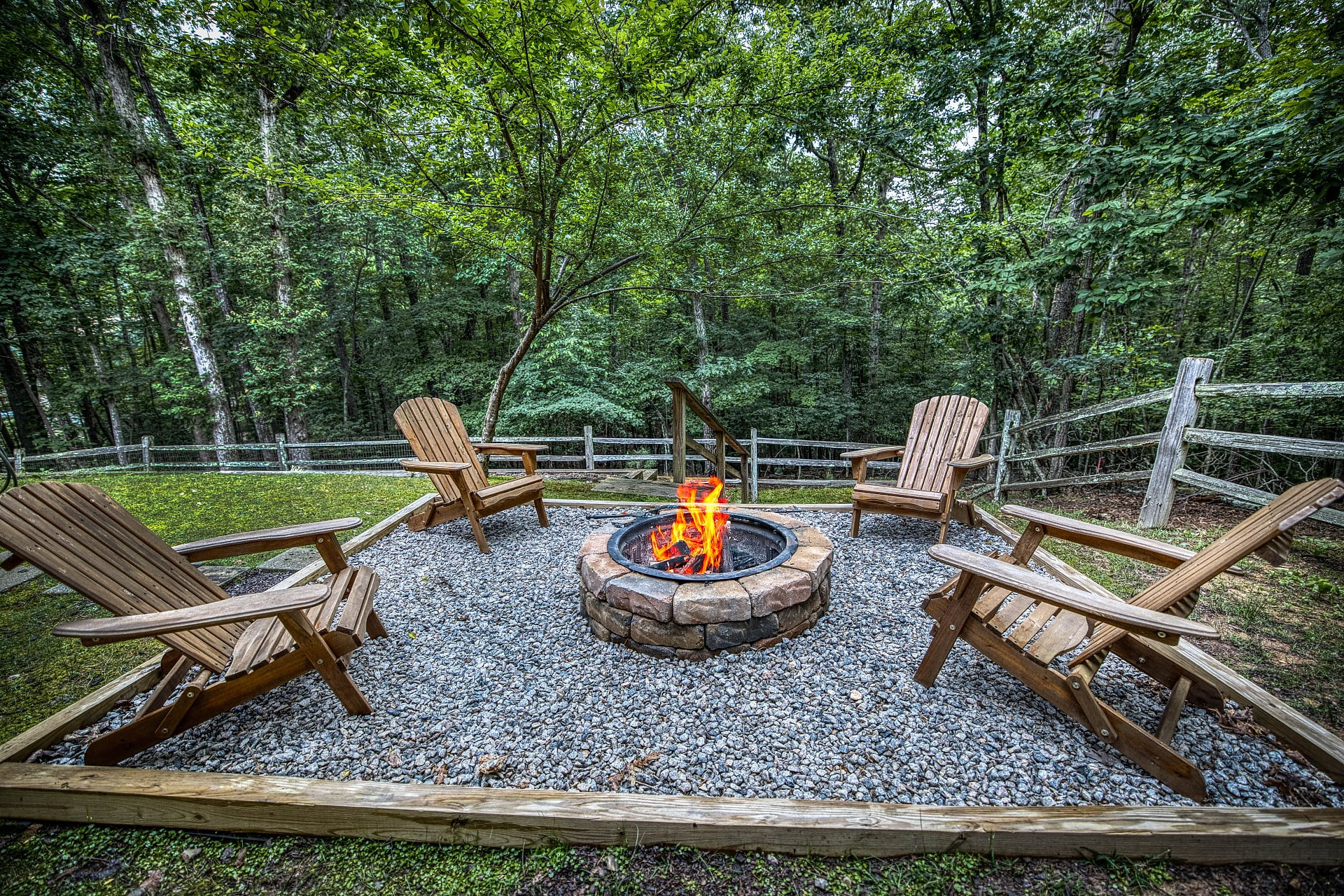 Private woodland firepit with Adirondack chairs for stargazing nights