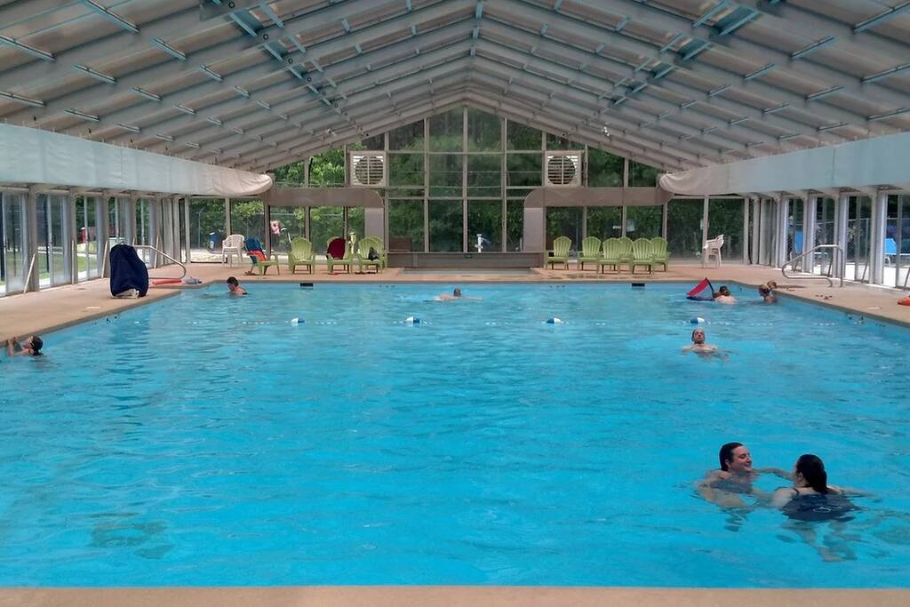 Enjoy a swim in the large heated indoor pool at the recreation center, open year-round for your convenience. Whether you're looking to relax or get active, this inviting space is perfect no matter the season! Enjoy a swim in the large heated indoor pool at the recreation center, open year-round for your convenience. Whether you're looking to relax or get active, this inviting space is perfect no matter the season! - Spacious Cabin, Hot Tub, Theater, Dog Run, FirePit - Ellijay