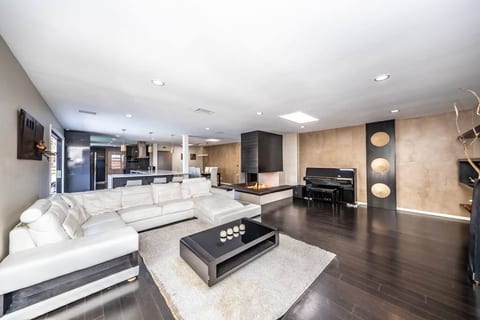Modern elegance meets cozy comfort in this open-concept living space, stylish decor, and a plush sectional perfect for relaxation. Ideal for entertaining or unwinding after a long day!