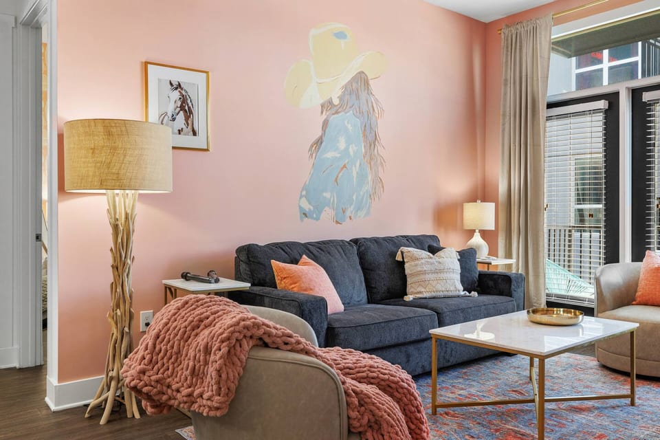 Living Room | Luxe Cowgirl Mural Wall | Main Floor
Unwind in style with plush seating, soft textures, and our signature cowgirl mural—bringing bold Western flair to this cozy-chic hangout spot just steps from Broadway.
