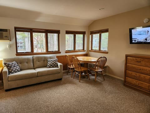 These room has multiple windows which let in great light and and lovely views. In the main room of the condo you will find a new couch to relax on. As well as an extra chair for seating along with seating for 6 around the table for dining.