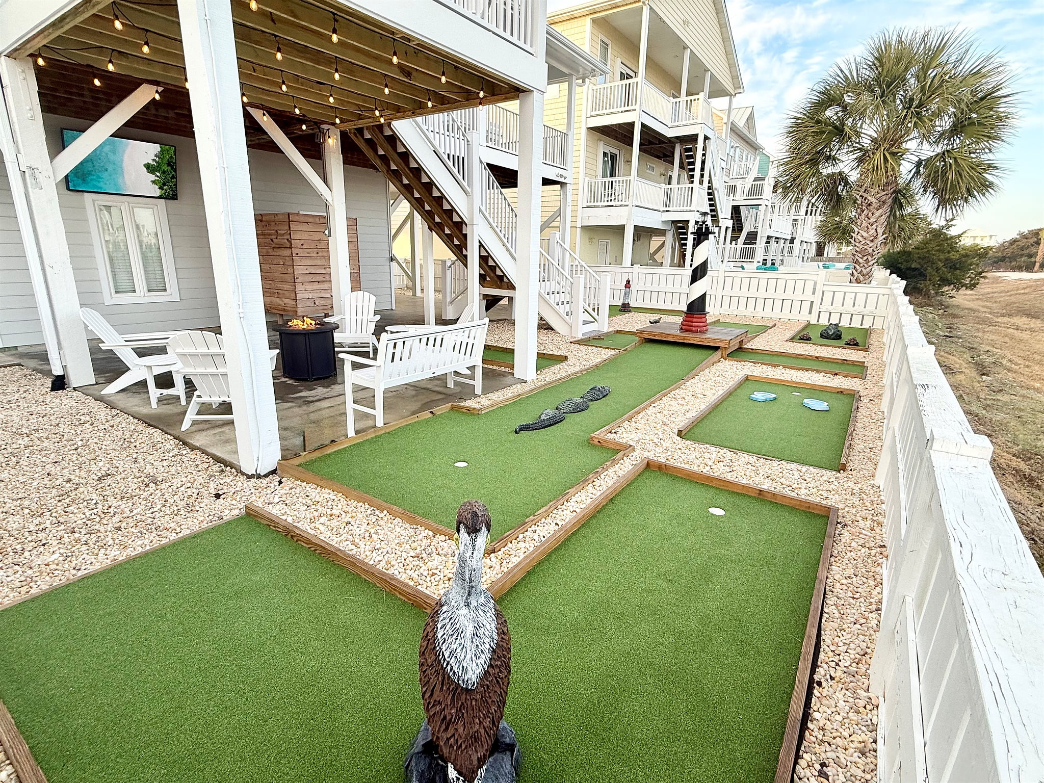 Backyard putt putt with fire pit and TV