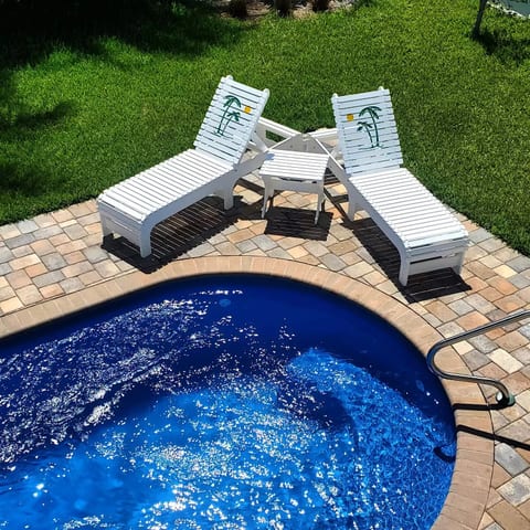 Private pool with chaise (2), umbrella, and sitting chairs (2).