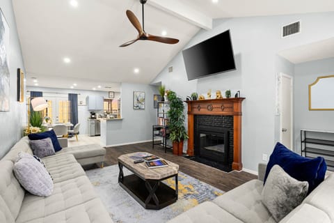 Relax and enjoy the wall-mounted TV from the comfortable sectional in this bright, open-concept space.