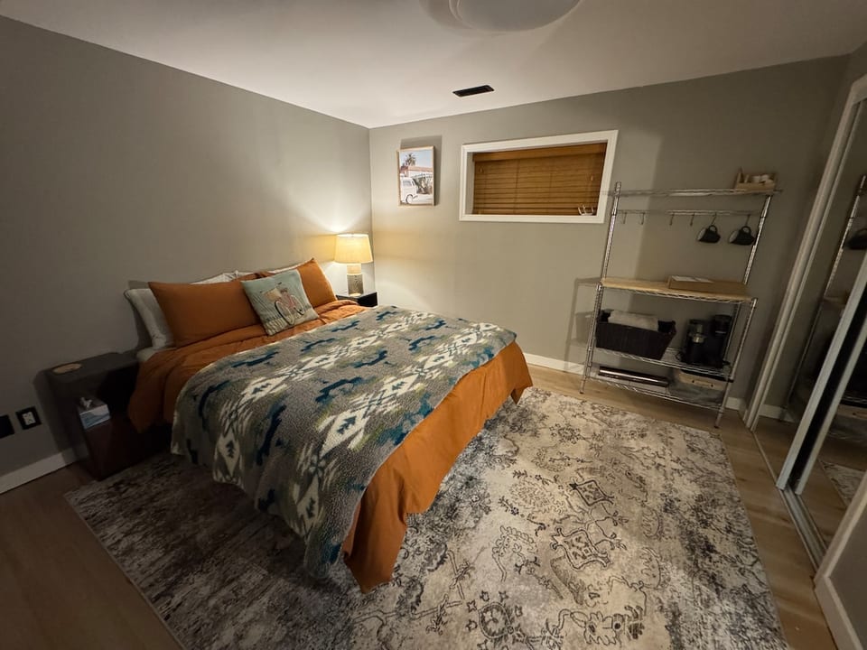 A queen bed in the secondary bedroom