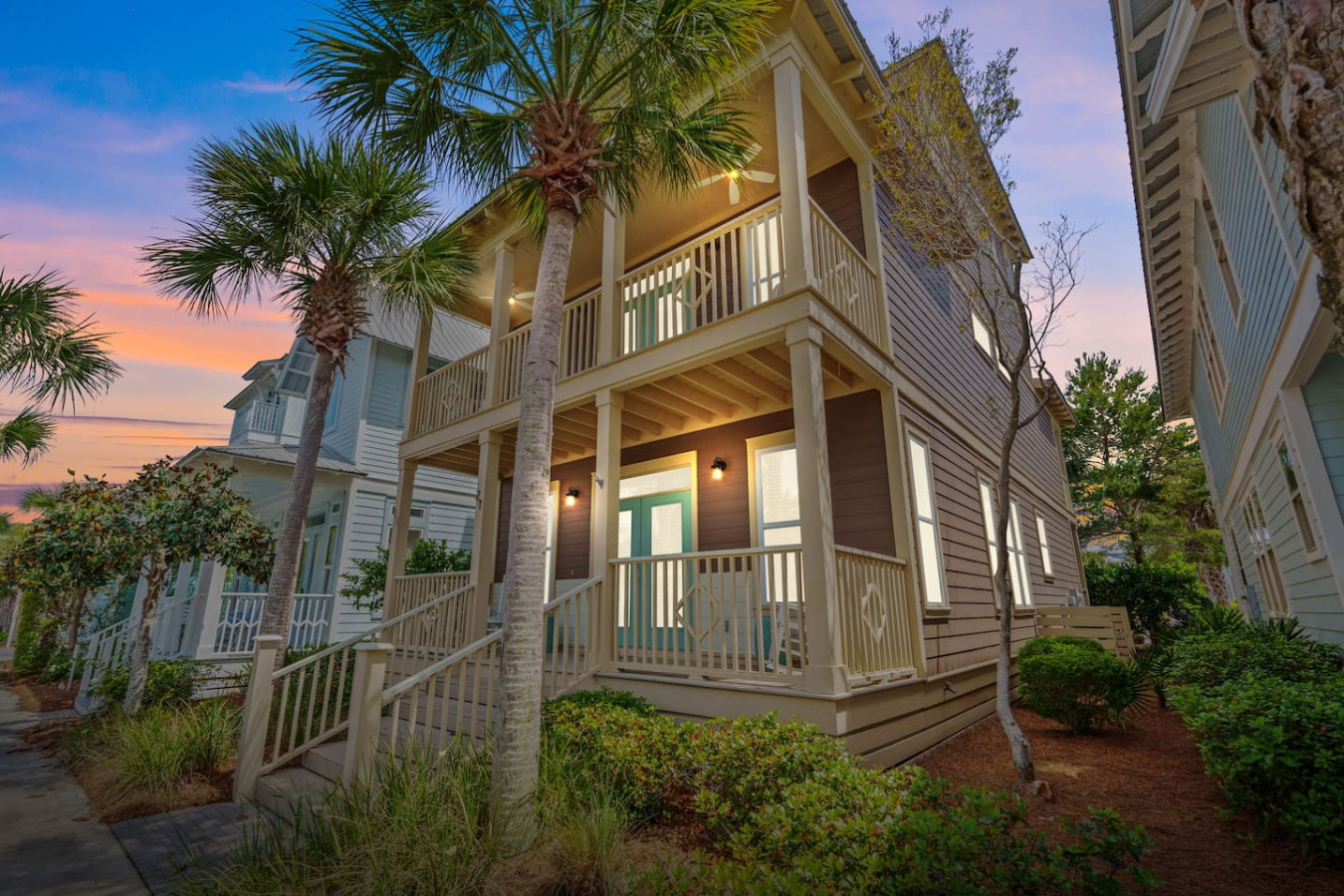 Bask in the glow of golden hour at this stunning 4-bedroom Seacrest Beach retreat with inviting double porches and tropical charm.