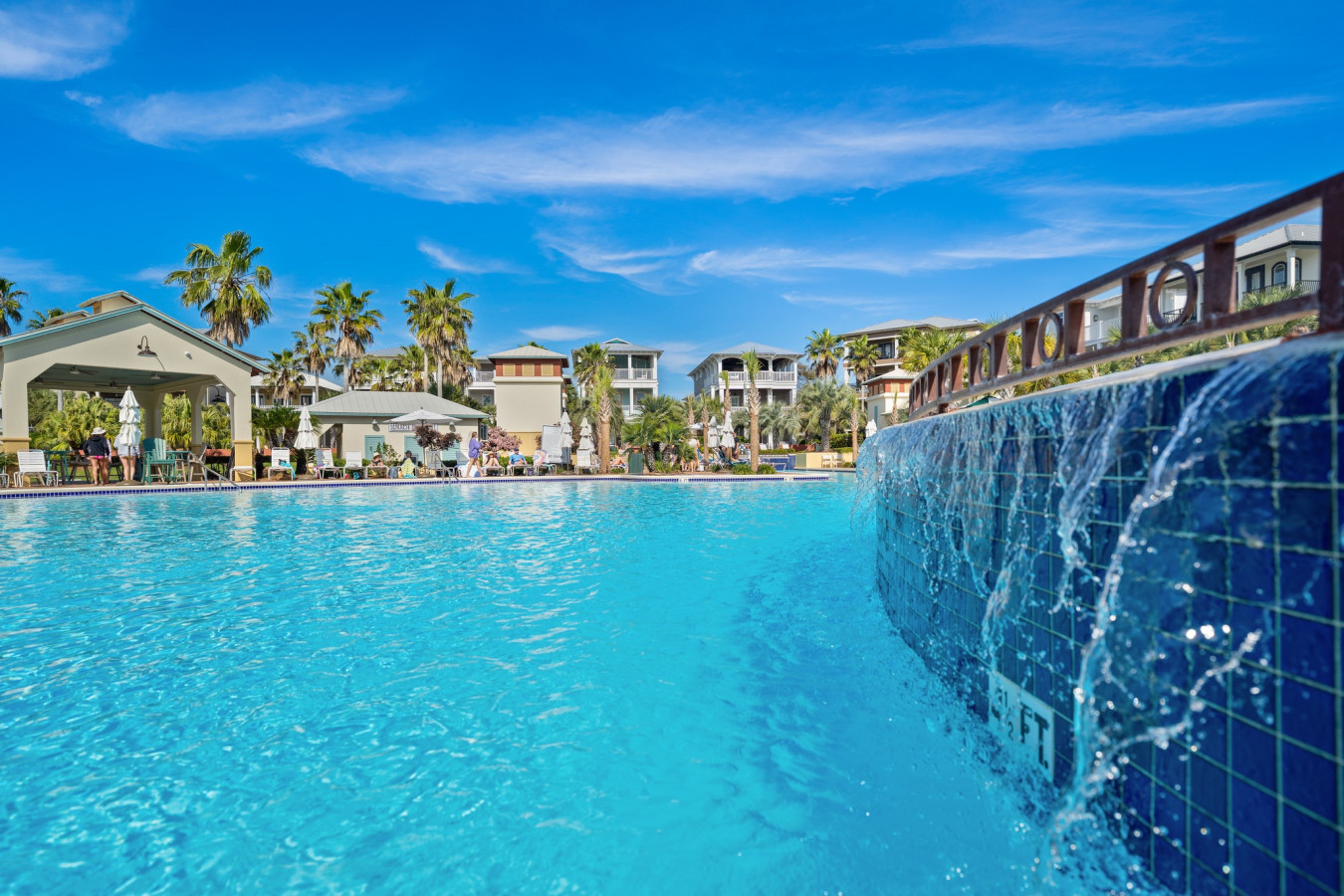 Relax by the tiered waterfall feature that adds a touch of tropical tranquility to the Seacrest Beach pool area.