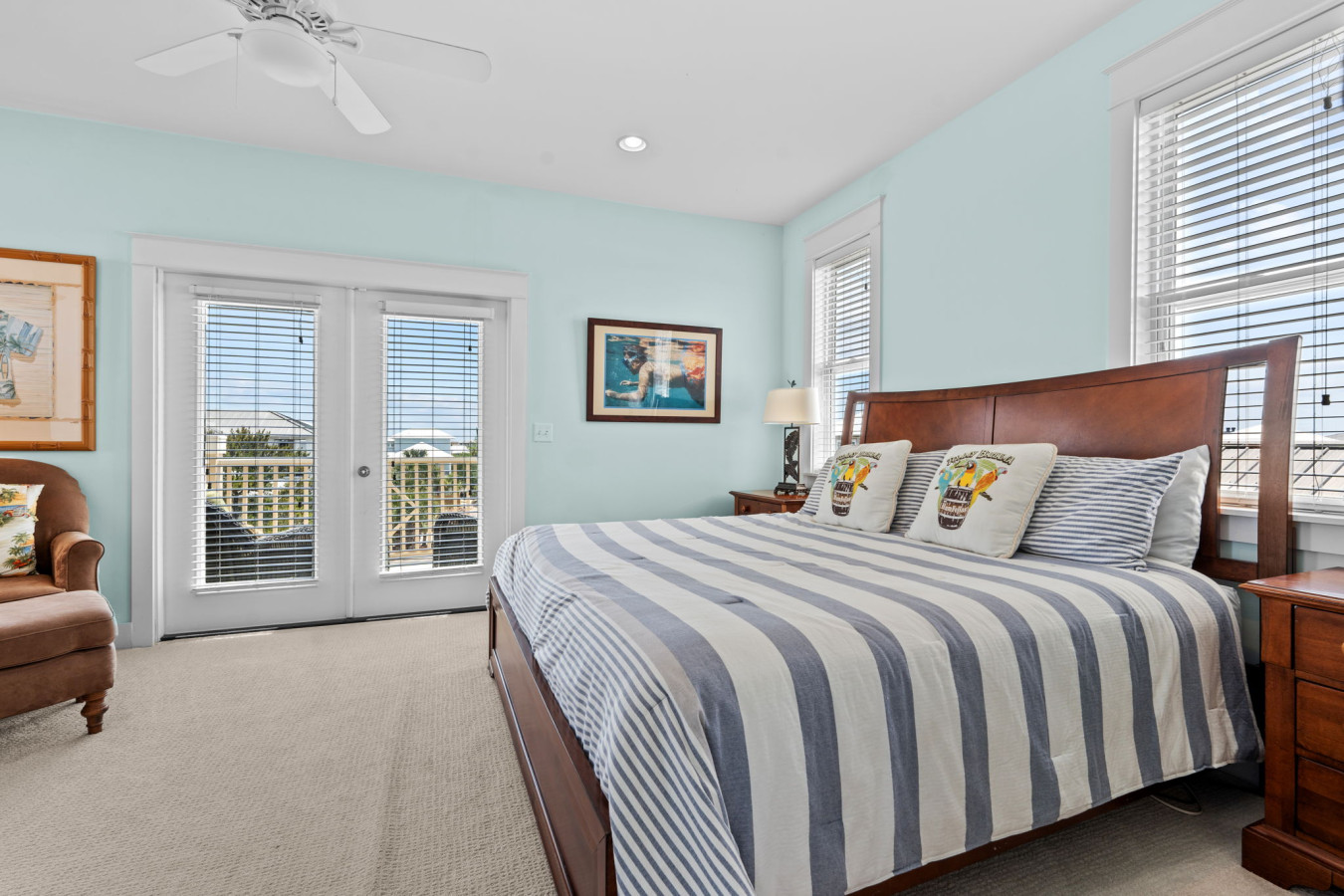 Spacious bedroom with king bed, comfy seating, and private balcony access.