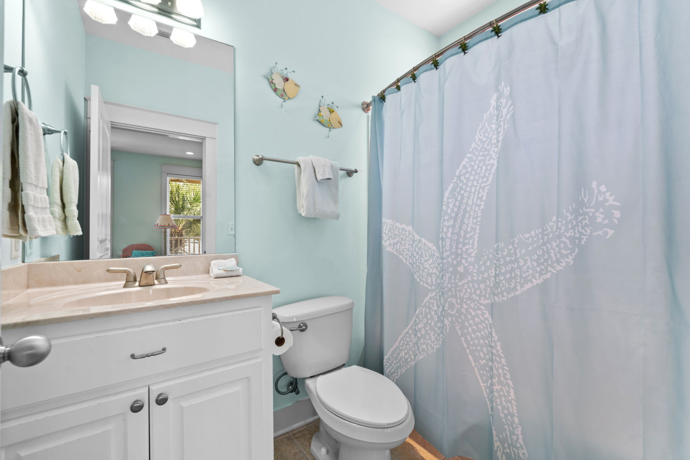 The master en-suite bathroom offers a full tub and shower, beachy accents, and plenty of counter space for your essentials.