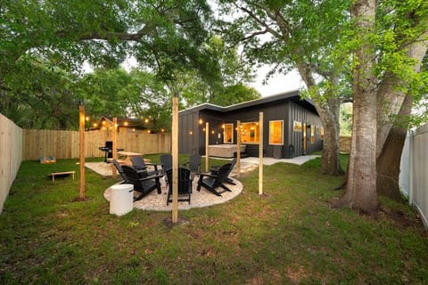 Fully fenced yard with yard games, hot tub, BBQ, outdoor seating and fire pit