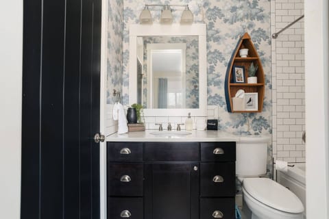 Guest bathroom in hallway that also connects to guest bedroom with a pocket door.
