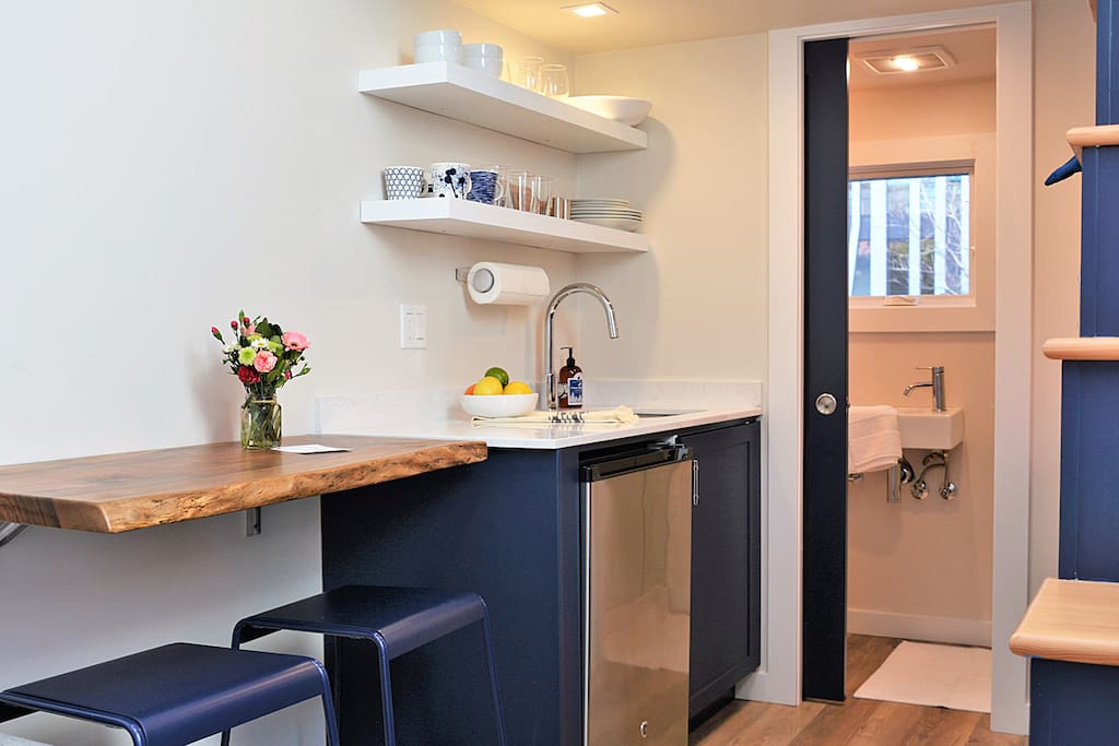 A kitchen with custom piano-hinged slab.