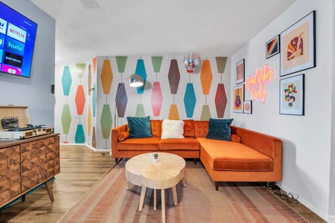 Groovy vibes and far-out charm in this retro-inspired living room - where neon signs and funky patterns take center stage!