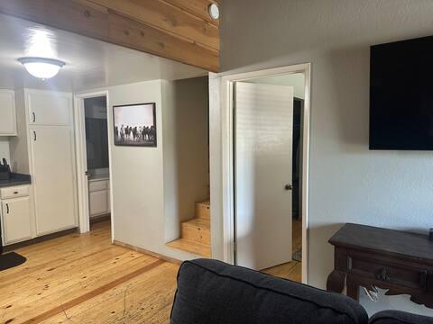 Picture taken from living room showing: doorway to restroom, stairs to loft, & masterbedroom