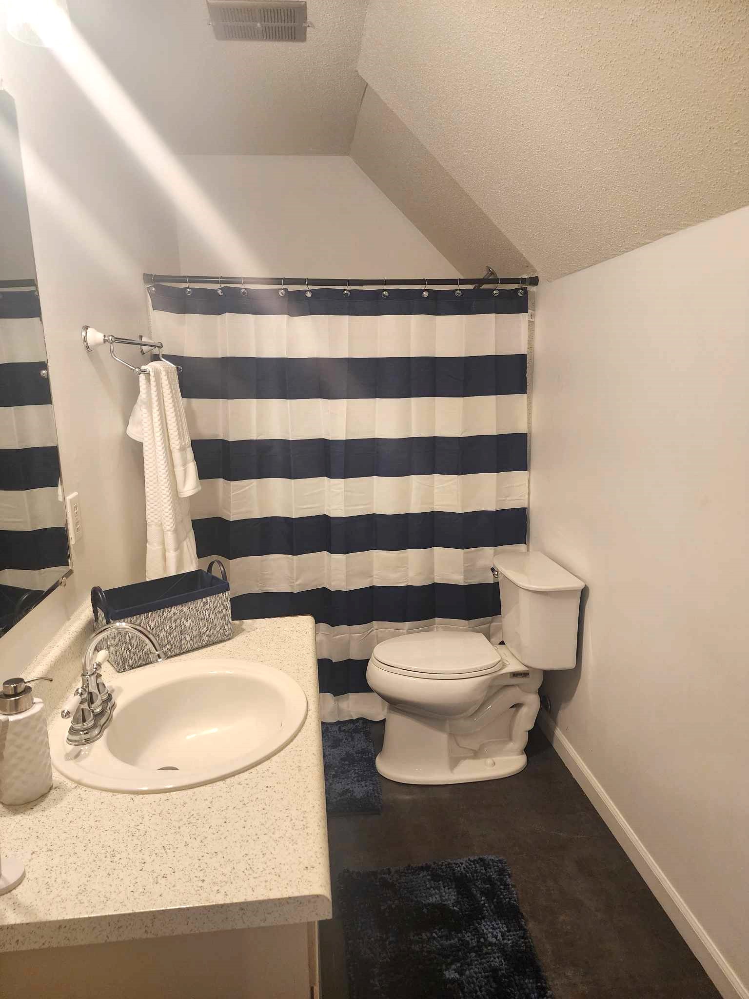 Bathroom #2: Complete Bathroom Experience: Stocked with Toiletries, Bathtub Shower, and a Vanity Mirror for Your Convenience.