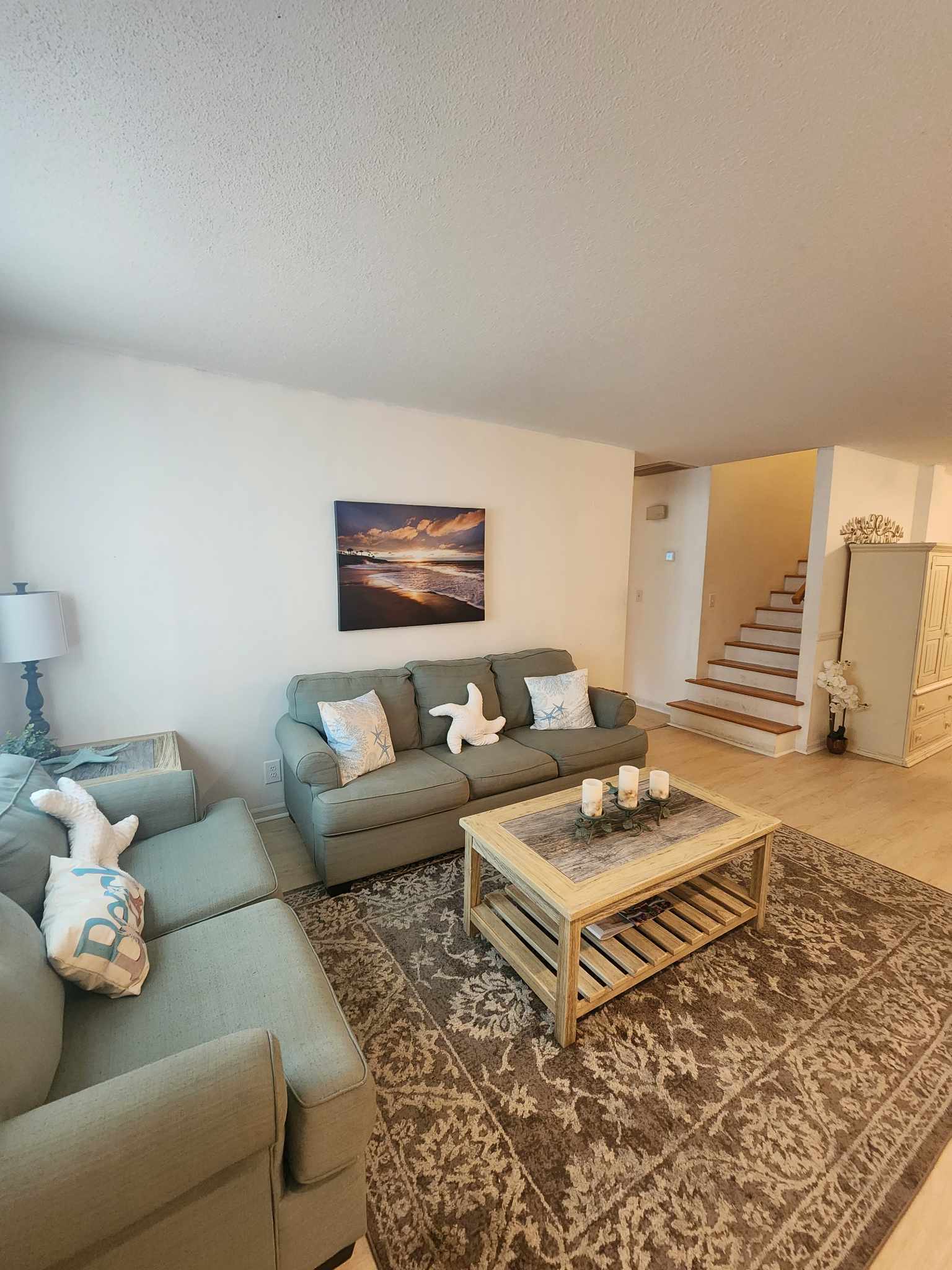 Inviting Living Space with Beach Getaway-Inspired Cushions for a Relaxing Retreat.