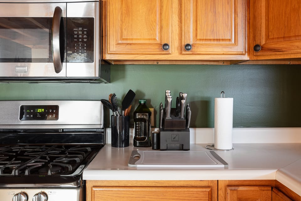 Well-equipped kitchen with gas stove, prep space, and warm wood cabinets