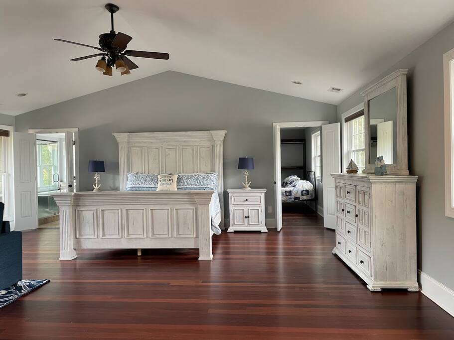 Indulge in this spacious top-level master suite, featuring a private balcony with stunning lake views. It includes an en-suite bathroom, and a unique walk-in closet transformed into a cozy sleeping nook. A sleeper sofa offers added flexibility. Indulge in this spacious top-level master suite, featuring a private balcony with stunning lake views. It includes an en-suite bathroom, and a unique walk-in closet transformed into a cozy sleeping nook. A sleeper sofa offers added flexibility. - Chalet on Lake Wylie, Waterfront w/Beach/Sleeps 16 - Belmont