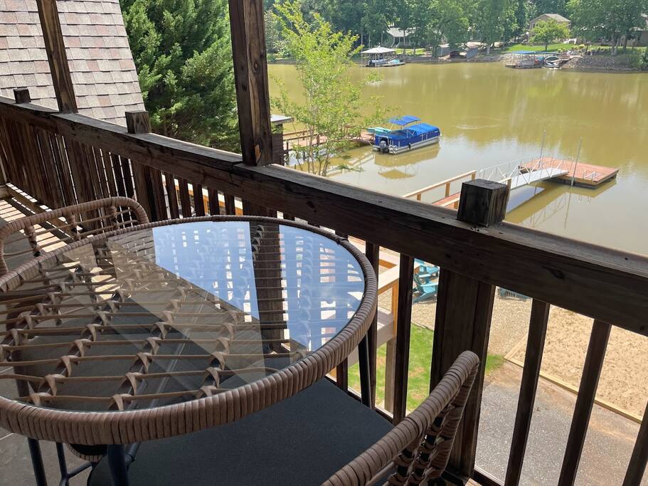 The master bedroom balcony has a nice view, and there's a table for two where you can sit and enjoy. It's a good spot for a quiet moment. The master bedroom balcony has a nice view, and there's a table for two where you can sit and enjoy. It's a good spot for a quiet moment. - Chalet on Lake Wylie, Waterfront w/Beach/Sleeps 16 - Belmont