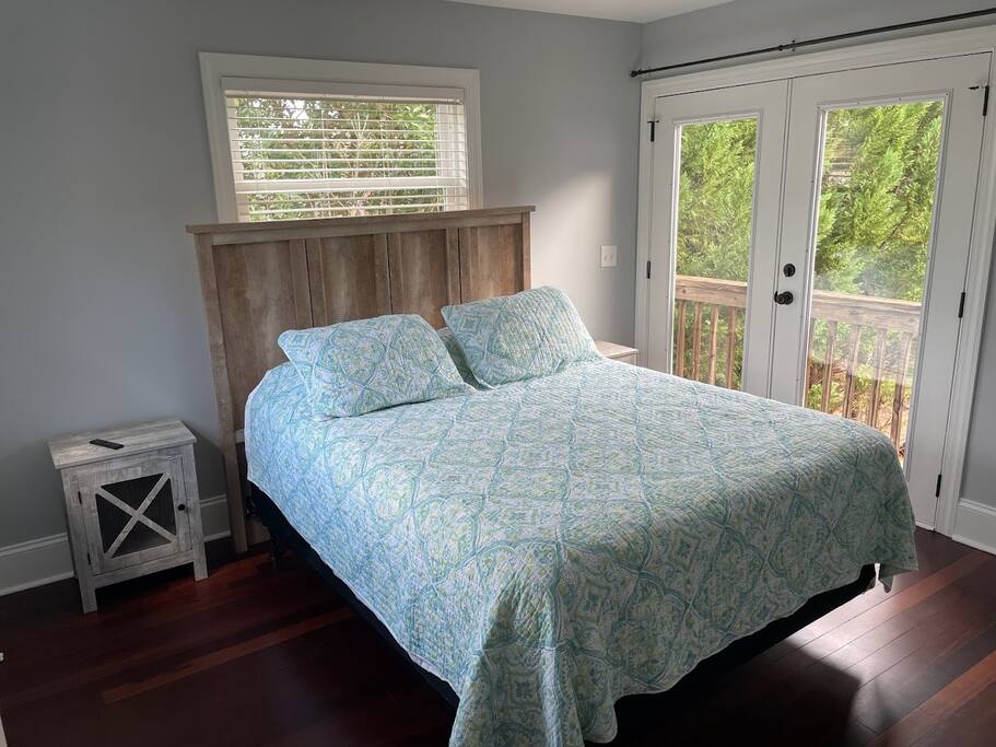 This serene corner bedroom offers an abundance of natural light and lake views, providing a tranquil retreat for your stay. Equipped with a smart TV, it's perfect for unwinding after a day of exploring or relaxing by the water. This serene corner bedroom offers an abundance of natural light and lake views, providing a tranquil retreat for your stay. Equipped with a smart TV, it's perfect for unwinding after a day of exploring or relaxing by the water. - Chalet on Lake Wylie, Waterfront w/Beach/Sleeps 16 - Belmont
