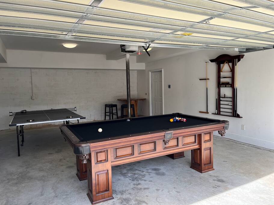 Experience the ultimate game room in our versatile garage. Play pool or ping pong, relax in the corner seating, and open the garage to create an airy, indoor-outdoor space. Enjoy breathtaking lake views and refreshing breezes while you play. Experience the ultimate game room in our versatile garage. Play pool or ping pong, relax in the corner seating, and open the garage to create an airy, indoor-outdoor space. Enjoy breathtaking lake views and refreshing breezes while you play. - Chalet on Lake Wylie, Waterfront w/Beach/Sleeps 16 - Belmont